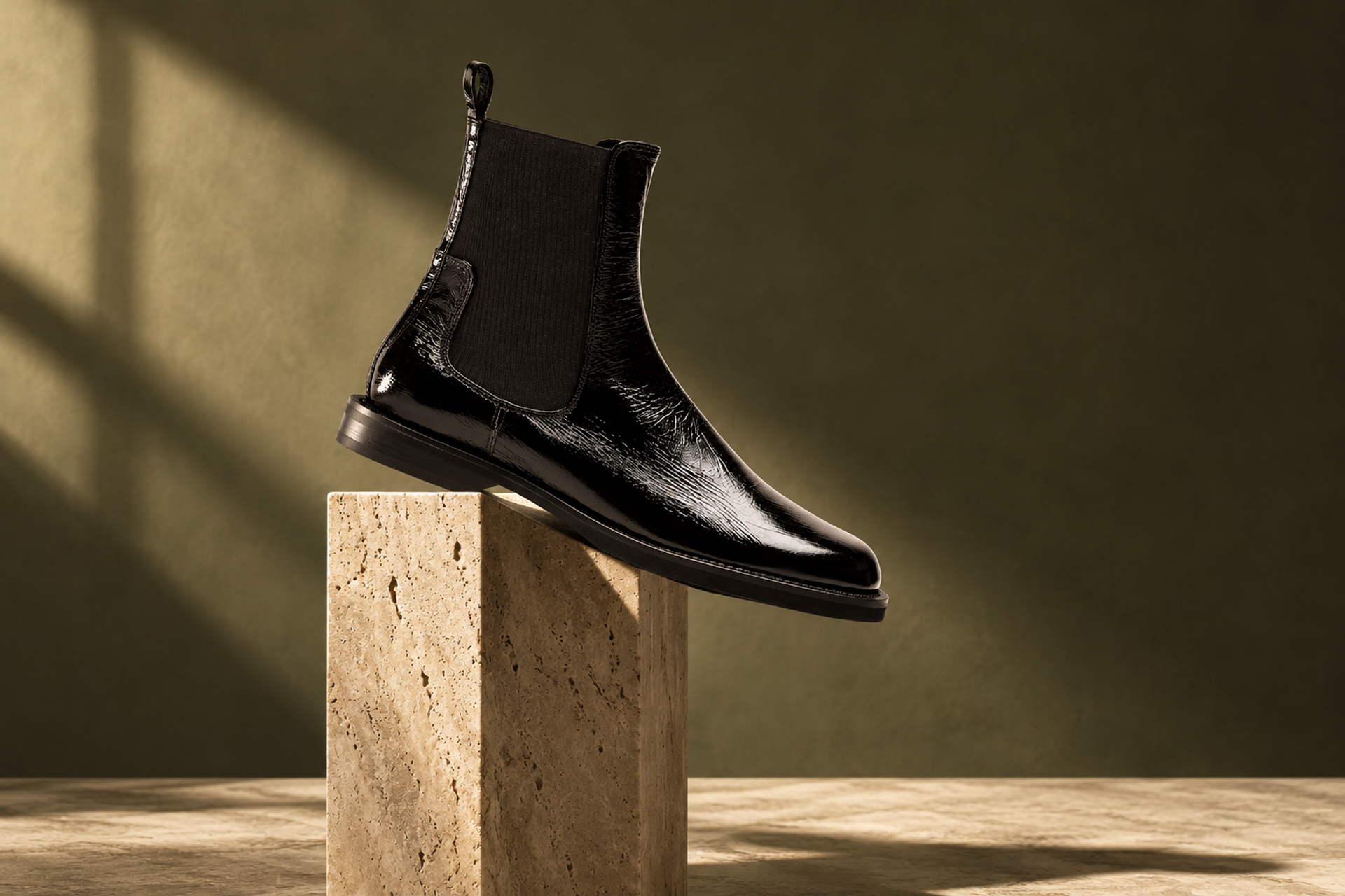 Best chelsea boots for women: La Canadienne Kindley black crushed leather chelsea boot on a travertine block